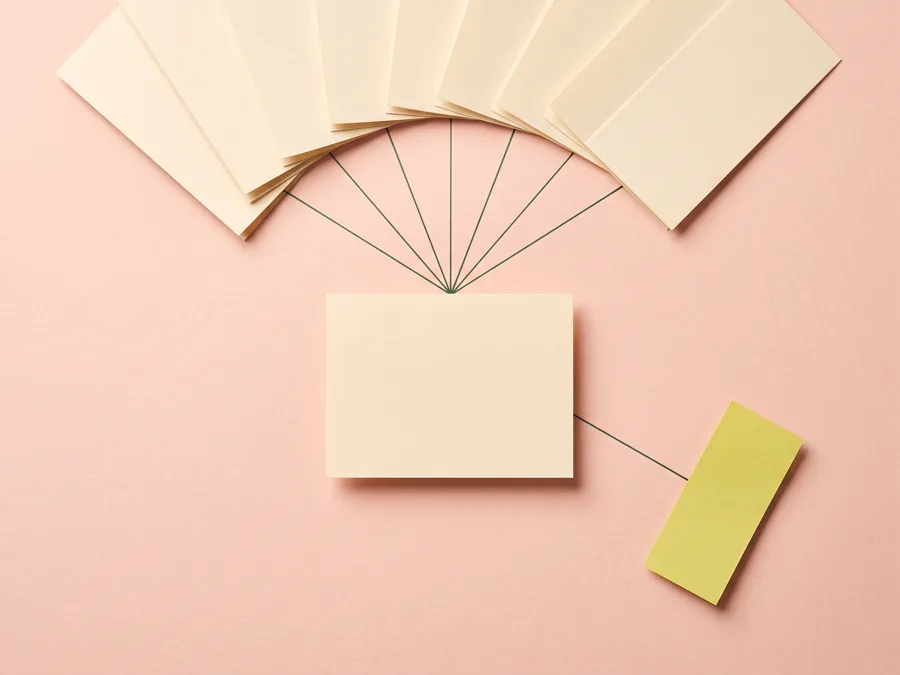 A fan of blank paper slips converging by fine ink lines into one card, with a single lime slip taking its own branch away.