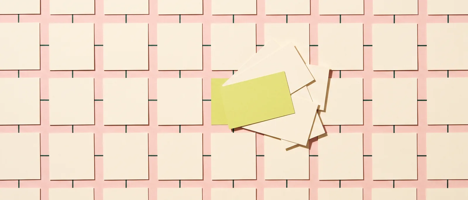 A large grid of identical blank cards joined by short ink lines, with one run broken: several cards piled out of alignment around a single lime slip.